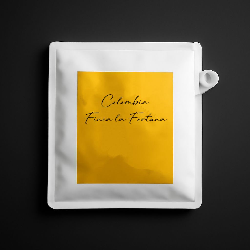 White coffee pod with a yellow label featuring 'Colombia Finca La Fortuna' on a black background